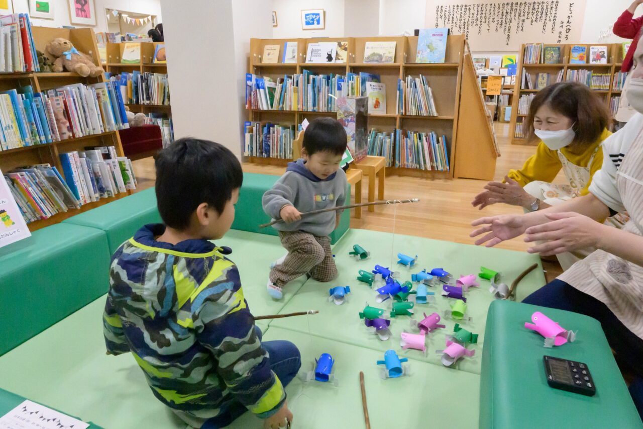 写真：男の子がかえる釣りをしています。